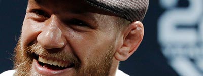 Conor McGregor smiling for the cameras at a UFC event.