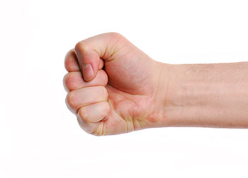 A fist punching from the right of shot.