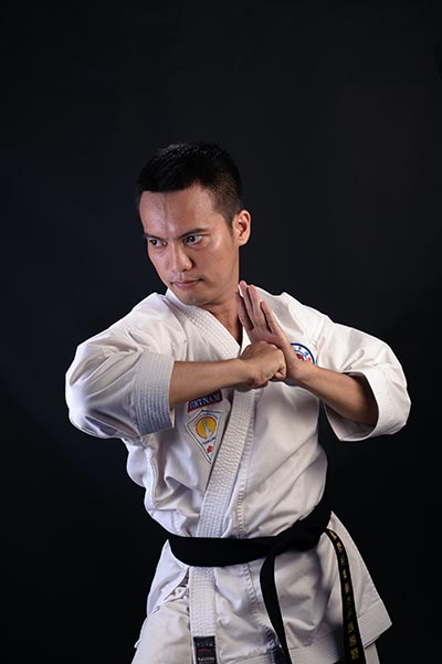 A Karate practitioner working on his form in the dojo.