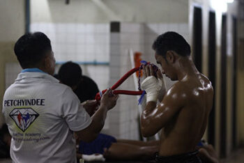 A Muay Thai fighter prepares for their fight.