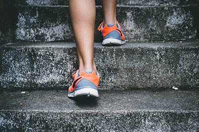A person running up steps in order to strengthen their leg muscles.