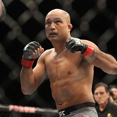 Two division UFC champion BJ Penn fighting inside the octagon.