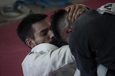 A Brazilian Jiu-Jitsu player uses a submission hold to try and submit his opponent.