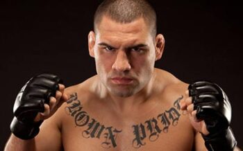 Cain Velasquez poses for the camera in UFC gloves.