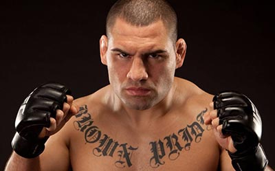 Cain Velasquez poses for the camera wearing UFC 4oz gloves.