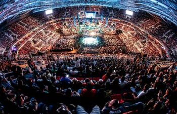 An arena full of fans watching some fights in the UFC.