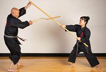 A master and student perform Kobudo martial art.