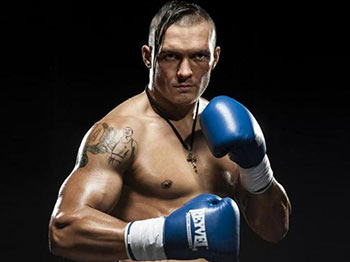 Oleksandr Usyk Ukraine wearing blue boxing gloves.
