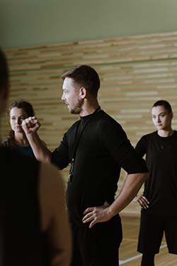 A coach instructing some professional athletes during a class.