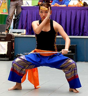 A female student performs a straddle stance for display.