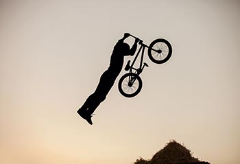 Extreme BMX cyclist doing a dangerous stunt.