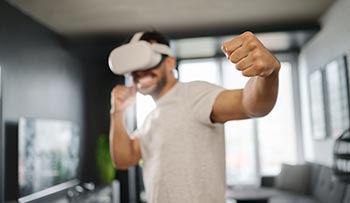A man in white T-shirt play VR boxing.